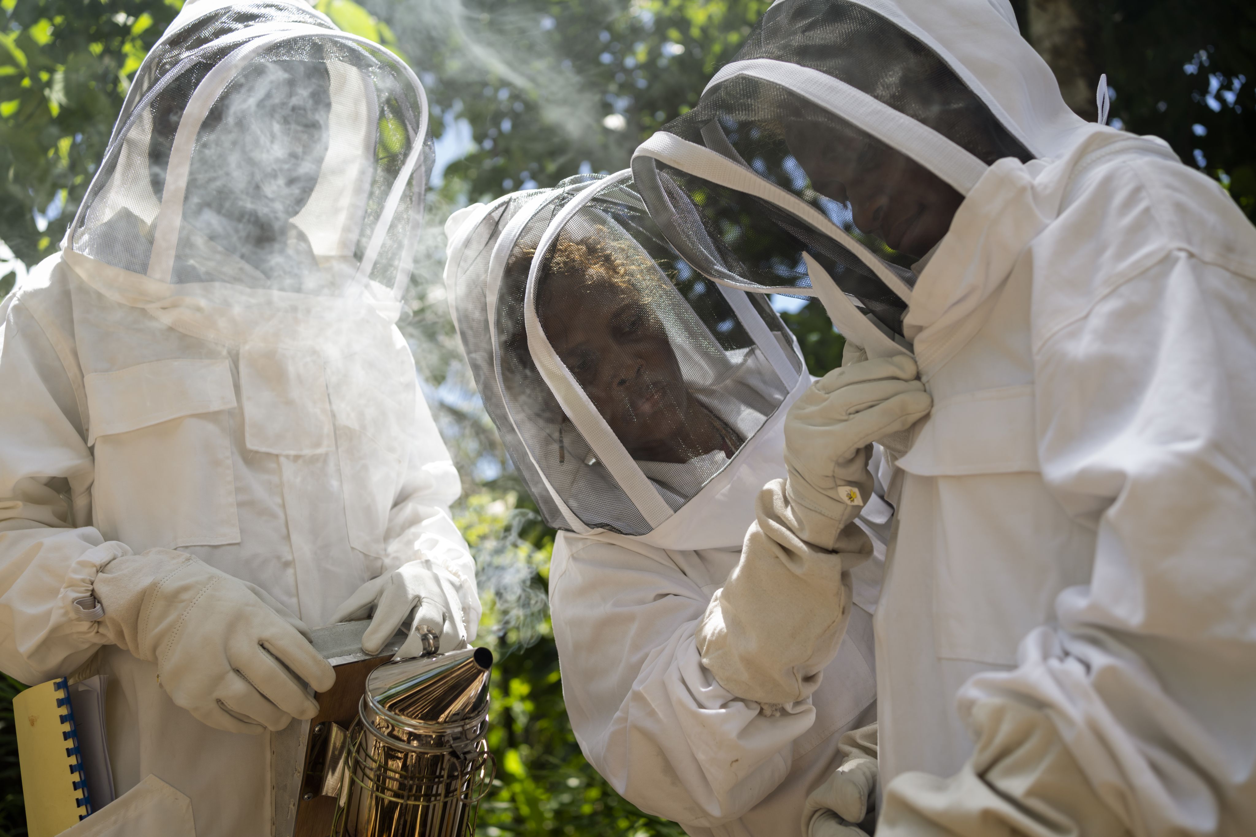 Alison, 43, adjusts Pristina’s veil during a bee keeping training session in a remote community in Malaita Province, the Solomon Islands.