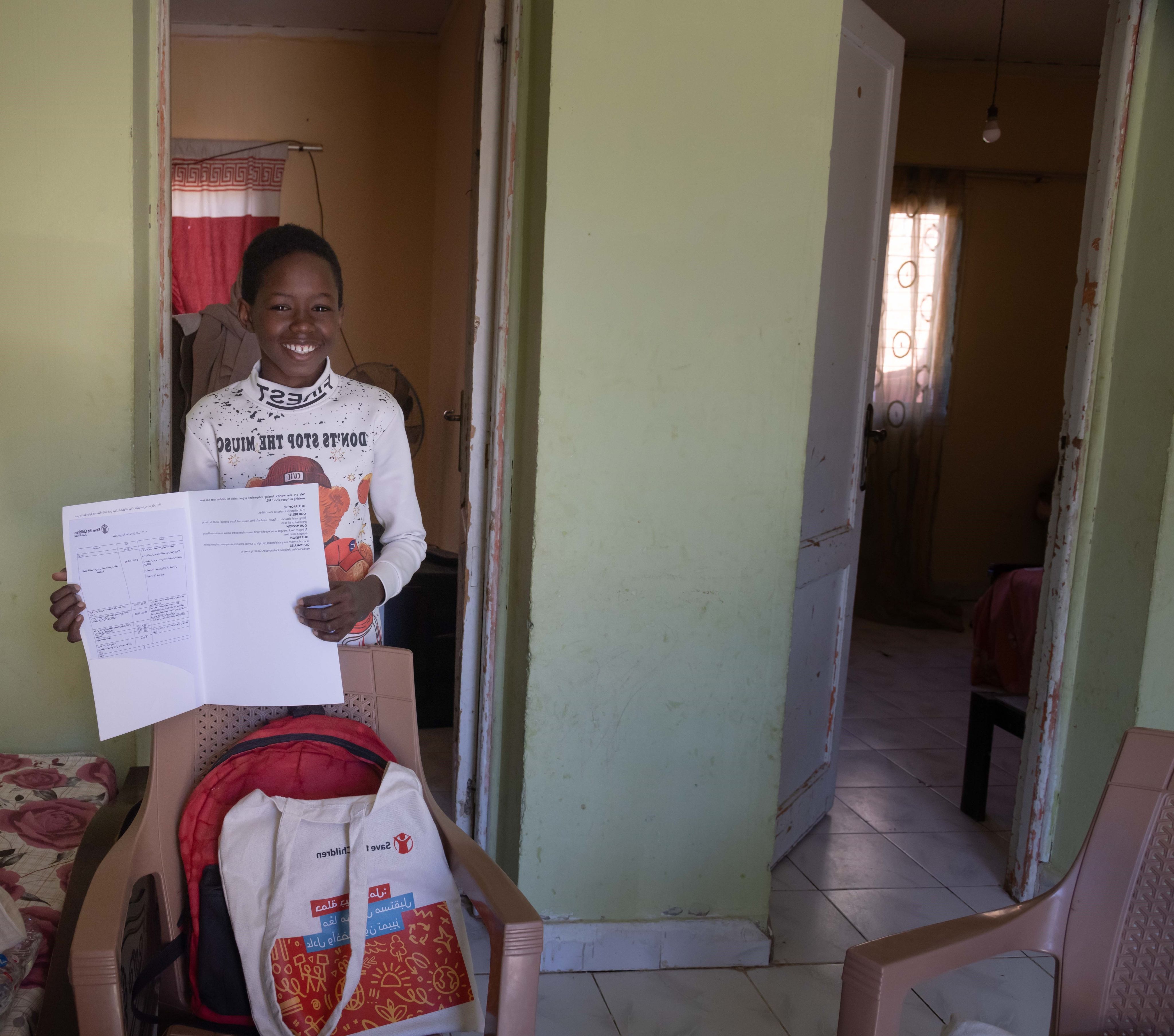 Asaad, 13, shows the invitation letter by Save the Children to attend COP27 as a speaker, in his home in Cairo, Egypt.